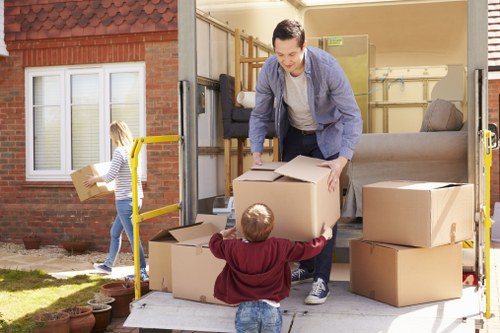 Professional movers planning a house removal in Canary Wharf near modern apartment buildings