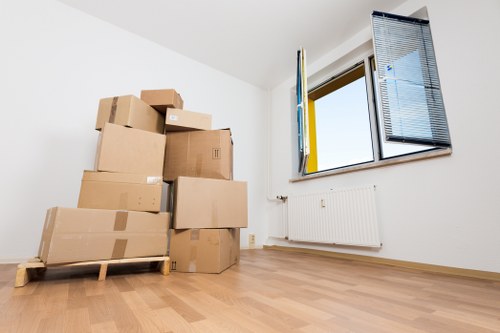 Packed moving boxes and furniture prepared for a Canary Wharf home relocation